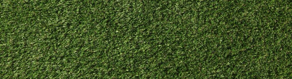 Close-up of synthetic turf blades and infill on an R & G Almanza Landscape Chicago turf installation
