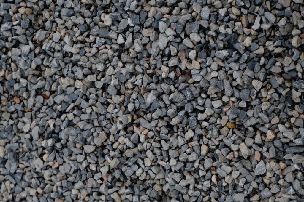 Crushed stone base compacted for a Chicago-area artificial turf installation by R & G Almanza Landscape